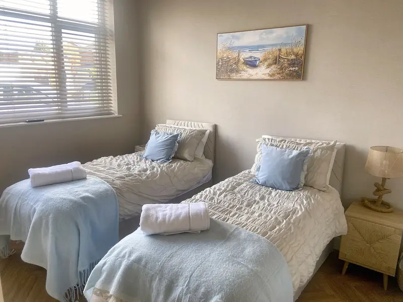 Second bedroom with two single beds made up as twins