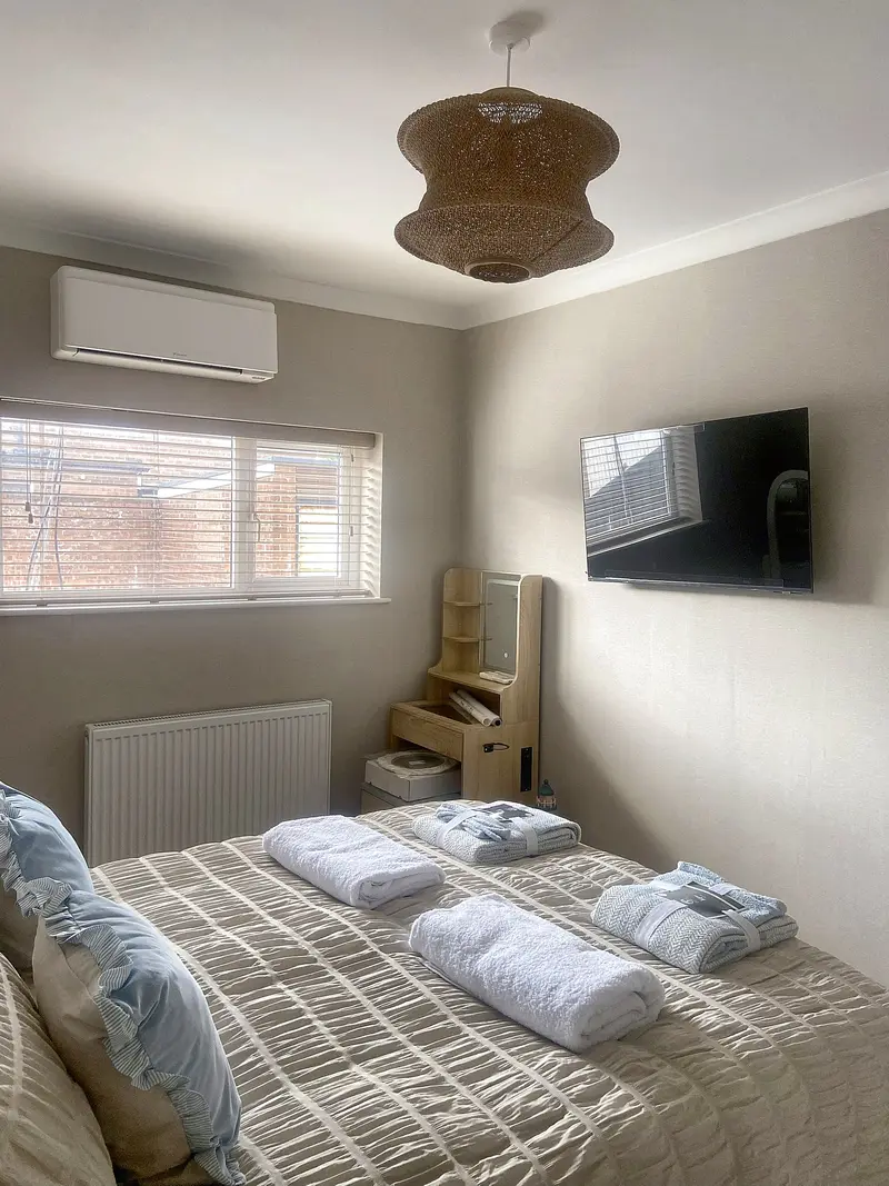 Bedroom with air conditioning and a wall-mounted smart TV